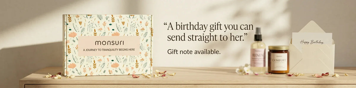 A birthday gift you can send straight to her, gift note available - the botanical gift box beside the body oil, the lit candle and a handwritten card in its envelope