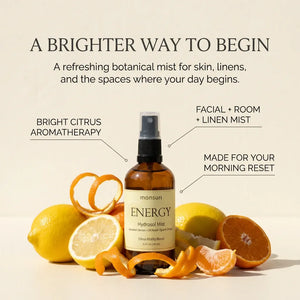 Monsuri ENERGY citrus hydrosol surrounded by lemons, oranges, and tangerines, labeled a brighter way to begin: bright citrus aromatherapy, facial and room and linen mist, made for your morning reset.