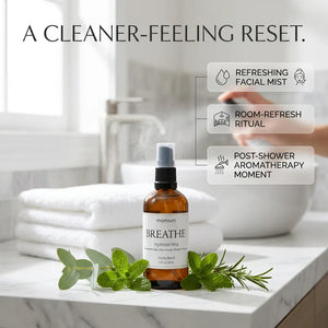 Monsuri BREATHE eucalyptus hydrosol styled on a bathroom counter with towels and fresh herbs, labeled a cleaner-feeling reset: refreshing facial mist, room-refresh ritual, post-shower aromatherapy moment.