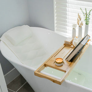 Full body bath pillow and bath caddy tray duo displayed on a bathtub