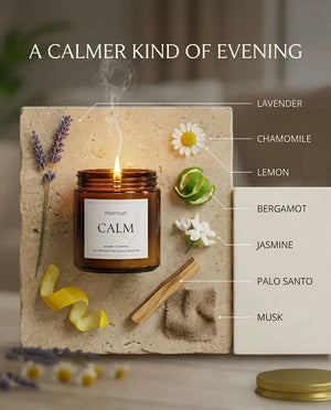 Monsuri CALM lavender chamomile candle styled on a stone tile with lavender, chamomile, lemon peel, bergamot, jasmine, palo santo, and musk labeled around it.