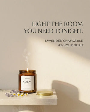 Monsuri CALM lavender chamomile candle burning on a stone shelf in soft afternoon light, captioned 'Light the room you need tonight' with a 45-hour burn callout.