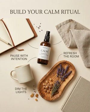 Monsuri CALM lavender hydrosol styled with a journal, mug, linen, and dried lavender on a wood tray, labeled build your calm ritual: pause with intention, refresh the room, dim the lights.