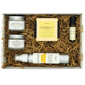 Sunshine box care package contents showing body butter, sugar scrub, and essential oil roller