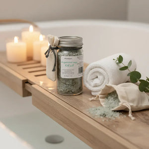 Magnesium Sage Bath Salts on a Bath Tray with Candles and Towel.