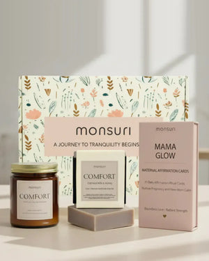 Mama Glow pregnancy and postpartum care set in front of the Monsuri botanical gift box - the COMFORT vanilla, amber and jasmine candle, the COMFORT oatmeal milk and honey soap bar, and the MAMA GLOW deck of 31 maternal affirmation-ritual cards