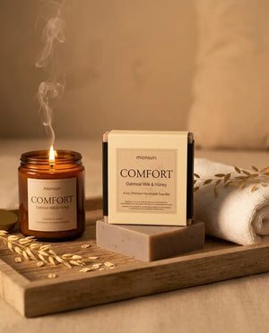 Oatmeal Milk & Honey soap box and bar on a wooden tray with a candle — natural soap for sensitive skin