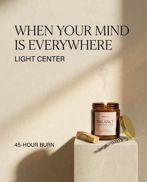 Monsuri BALANCE palo santo candle on a stone pedestal with the line 'When Your Mind Is Everywhere, Light Center' and its 45-hour burn time.