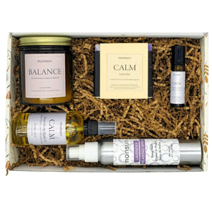 Classy retirement gift components: Balance Palo Santo Lavender candle, Calm shower mist, organic soap bar, body oil, travel roller