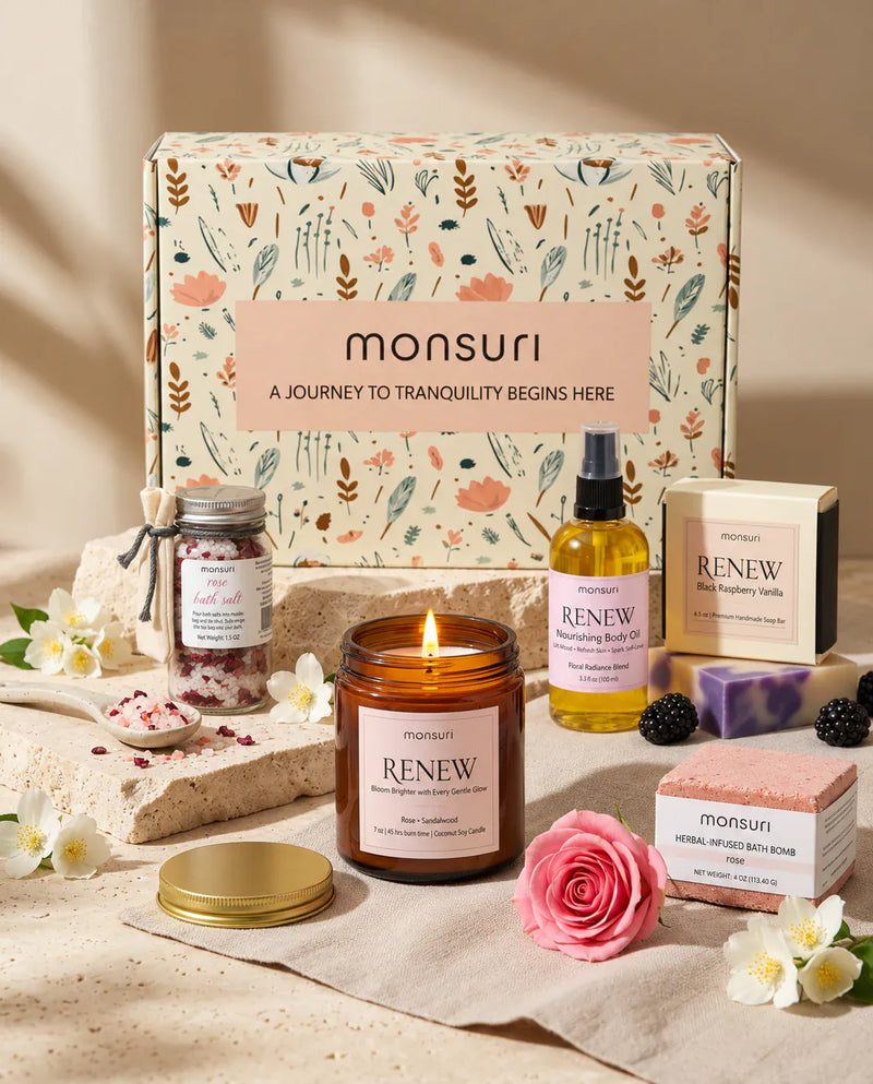 All five pieces of the romantic spa gift set in front of the botanical kraft box - rose bath salt 1.5 oz, RENEW rose and sandalwood candle 7 oz with 45 hour burn, nourishing body oil 3.3 fl oz, black raspberry vanilla soap 4.5 oz and herbal-infused rose bath bomb 4 oz