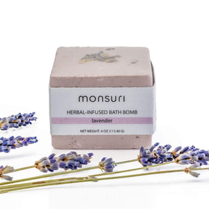 Luxurious lavender bath bomb placed against a white backdrop.