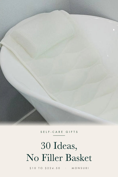 The Monsuri full-body bath pillow lining the sloped back of a white freestanding tub, under the cover line 30 Ideas, No Filler Basket.