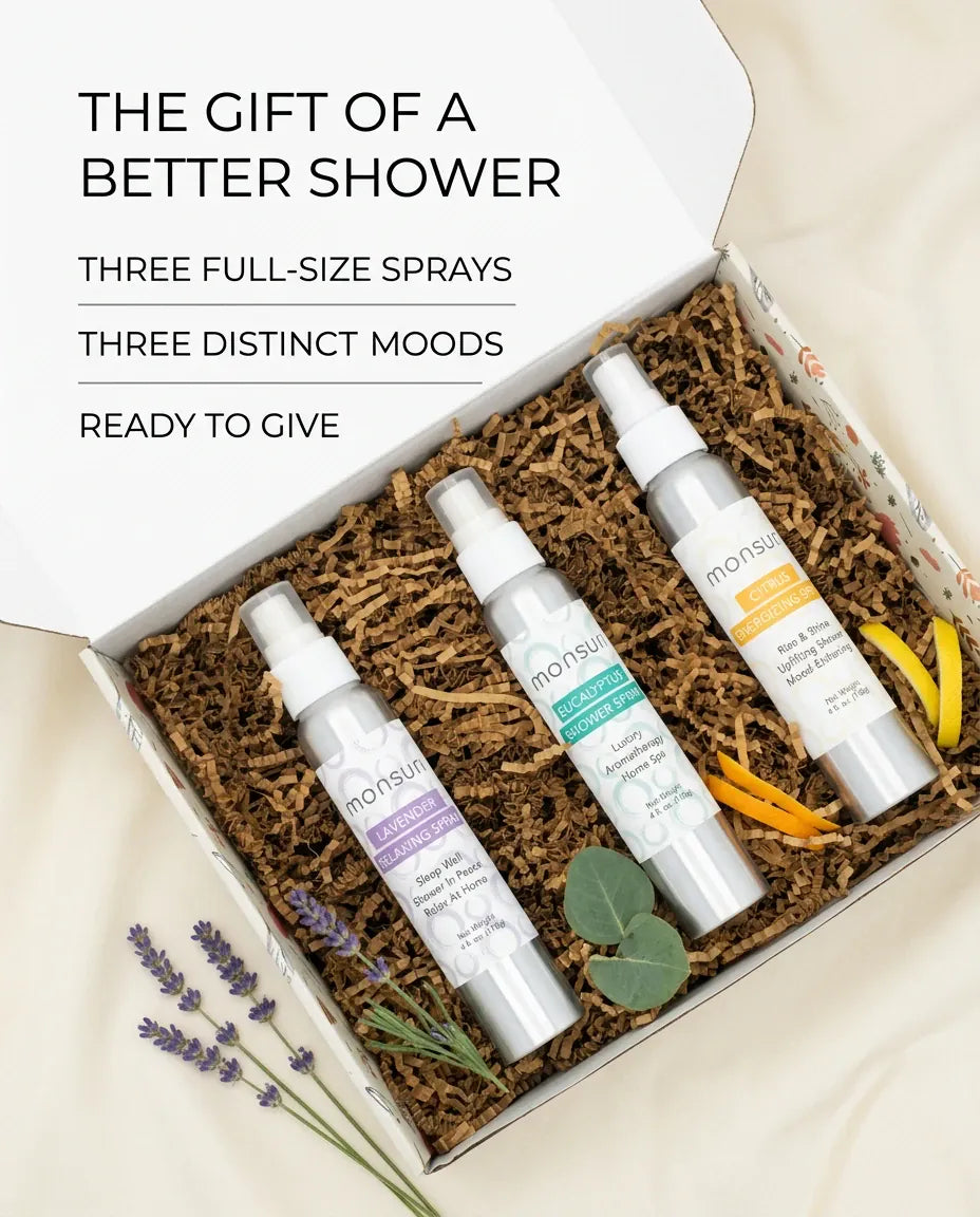 Opened Monsuri aromatherapy shower spray gift box on kraft shred showing all three full-size sprays, ready to give.