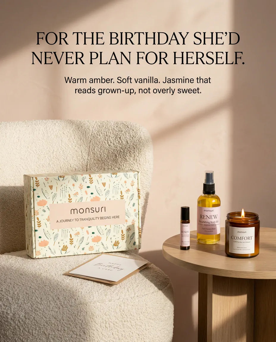 For the birthday she would never plan for herself - warm amber, soft vanilla and jasmine that reads grown-up rather than sweet, the gift box propped on a boucle chair beside the candle, body oil and roller