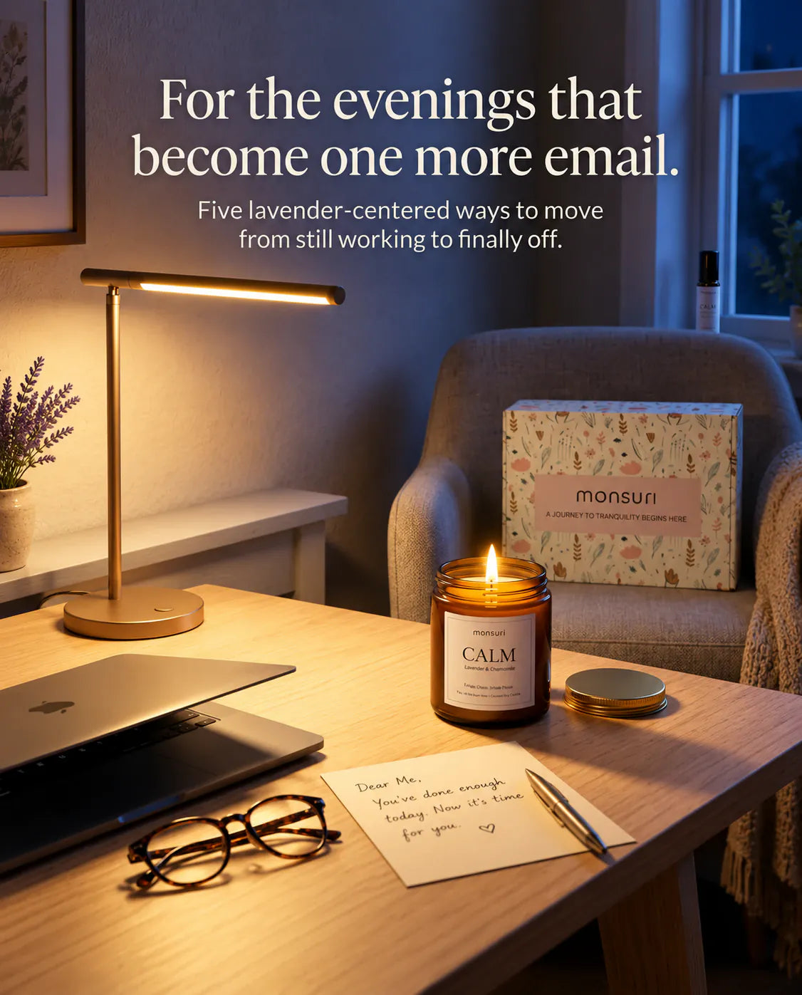 For the evenings that become one more email - the CALM lavender-chamomile candle lit on a desk beside a laptop, reading glasses and a handwritten note, with the botanical gift box on the armchair behind