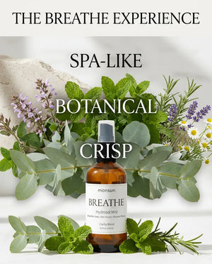 Monsuri BREATHE eucalyptus hydrosol surrounded by fresh herbs, labeled the BREATHE experience: spa-like, botanical, crisp.