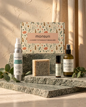The five Get Well Soon pieces arranged on stone plinths in front of the Monsuri botanical gift box with eucalyptus