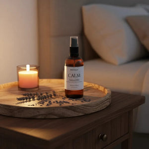 Lavender essential oil sleep pillow spray bottle on a bedside bedroom table