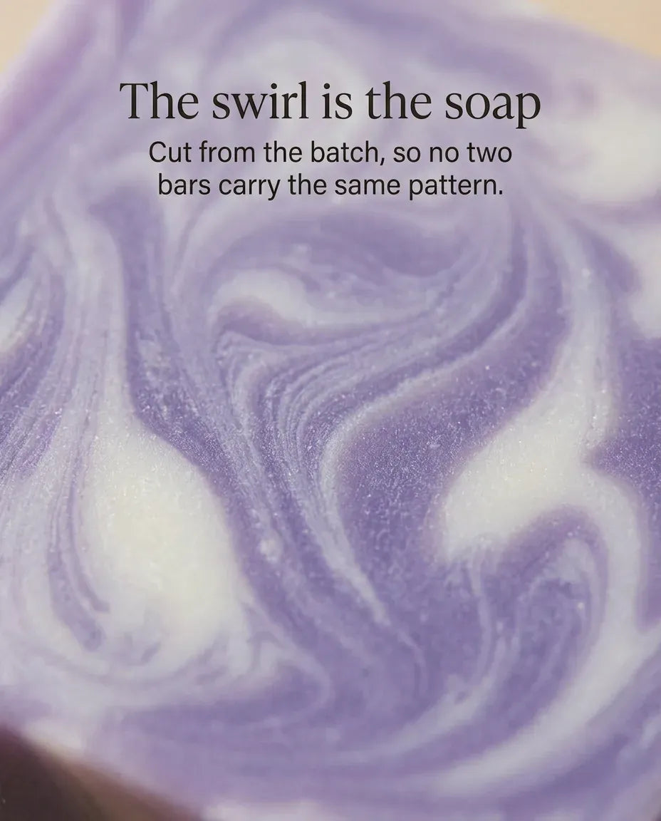 Each natural lavender soap bar is cut from the batch, so no two bars carry the same purple-and-cream swirl pattern.