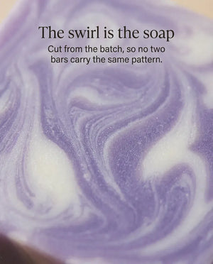 Each natural lavender soap bar is cut from the batch, so no two bars carry the same purple-and-cream swirl pattern.