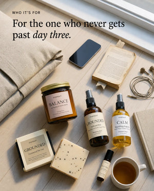 For the one who never gets past day three — the five pieces laid out overhead on pale floorboards beside a linen cushion, a phone face-up, an open paperback, earbuds and a cup of tea.