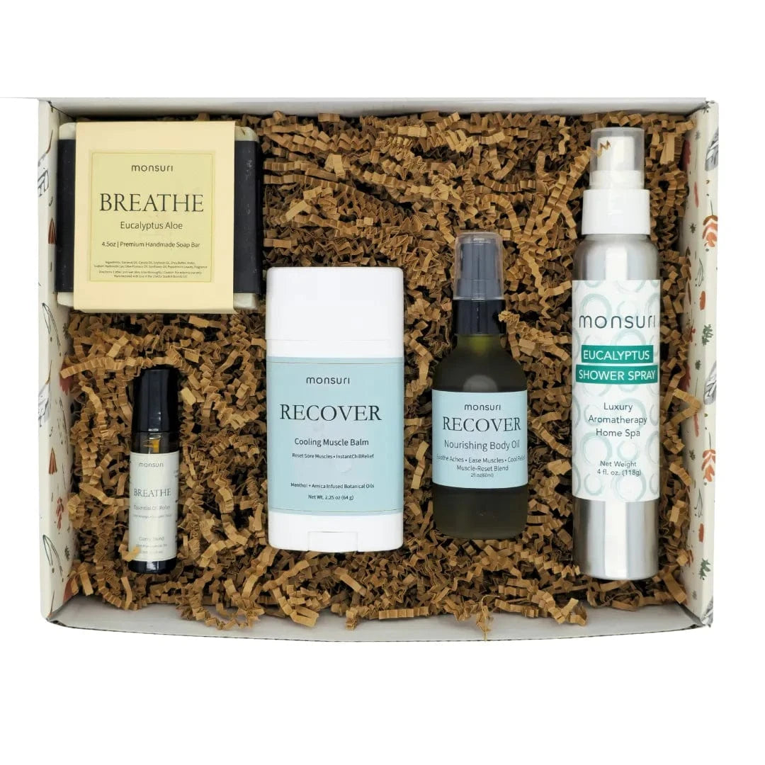 Post surgery care package with five healing products in Monsuri's botanical gift box with kraft shred packaging