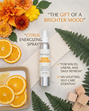 Monsuri citrus energizing shower spray styled with fresh orange slices and marigolds, labeled the gift of a brighter mood.