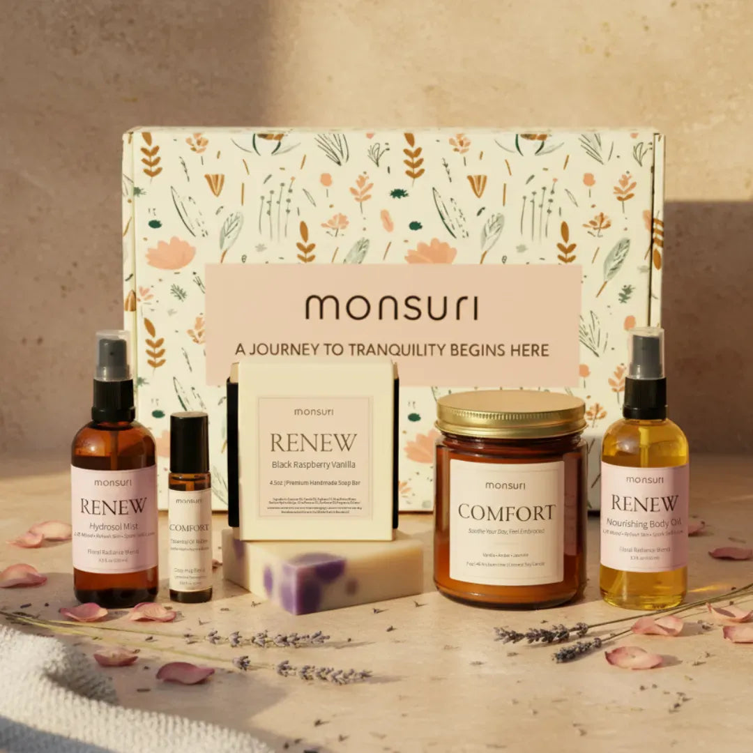 Thinking of you gift set with vanilla amber candle, raspberry vanilla soap, botanical body oil, hydrosol mist and essential oil roller arranged on marble surface