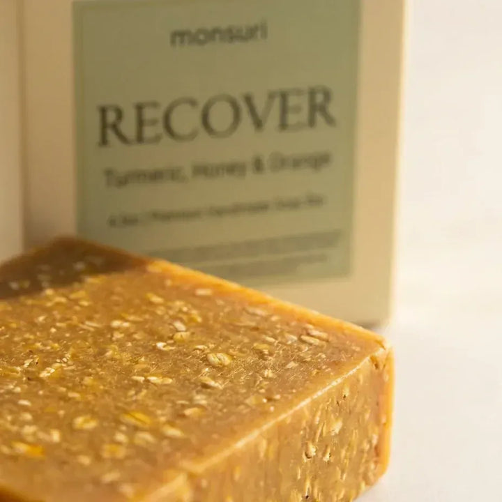 Close-up of the golden Turmeric Honey & Orange soap bar with exfoliant flecks — natural handmade soap bar