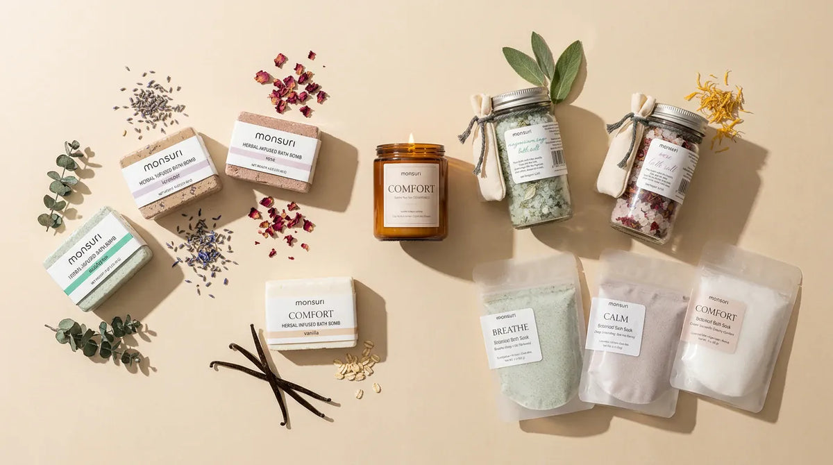 Overhead flat lay of all eleven pieces of the Ultimate Bath Gift Set spread on cream with eucalyptus, lavender, rose petals and vanilla pods