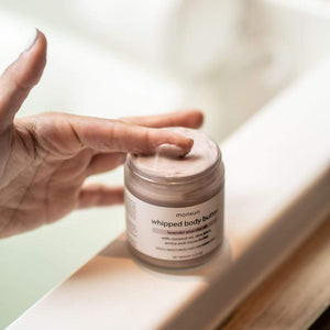 An open jar of Monsuri's Lavender Body Butter revealing its luscious consistency.