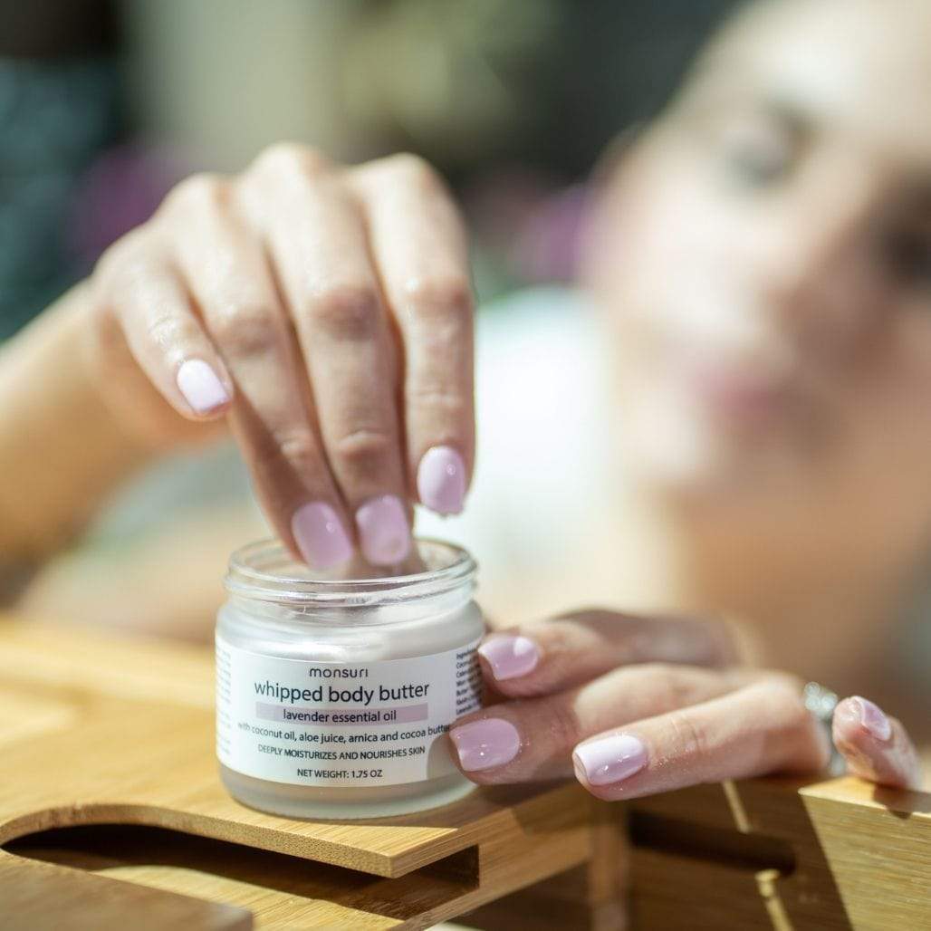 A flat lay composition of Monsuri's Lavender Body Butter with spa essentials.