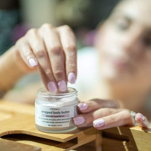 A flat lay composition of Monsuri's Lavender Body Butter with spa essentials.