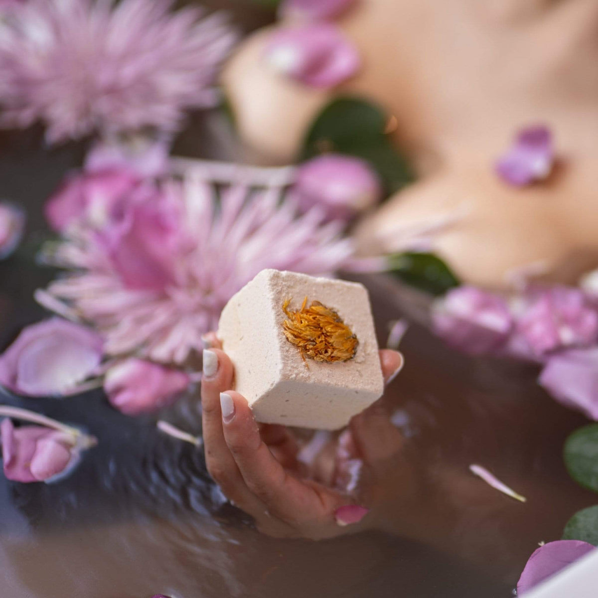 Vibrant yellow hues of Monsuri's energizing Lemongrass Bath Bomb.