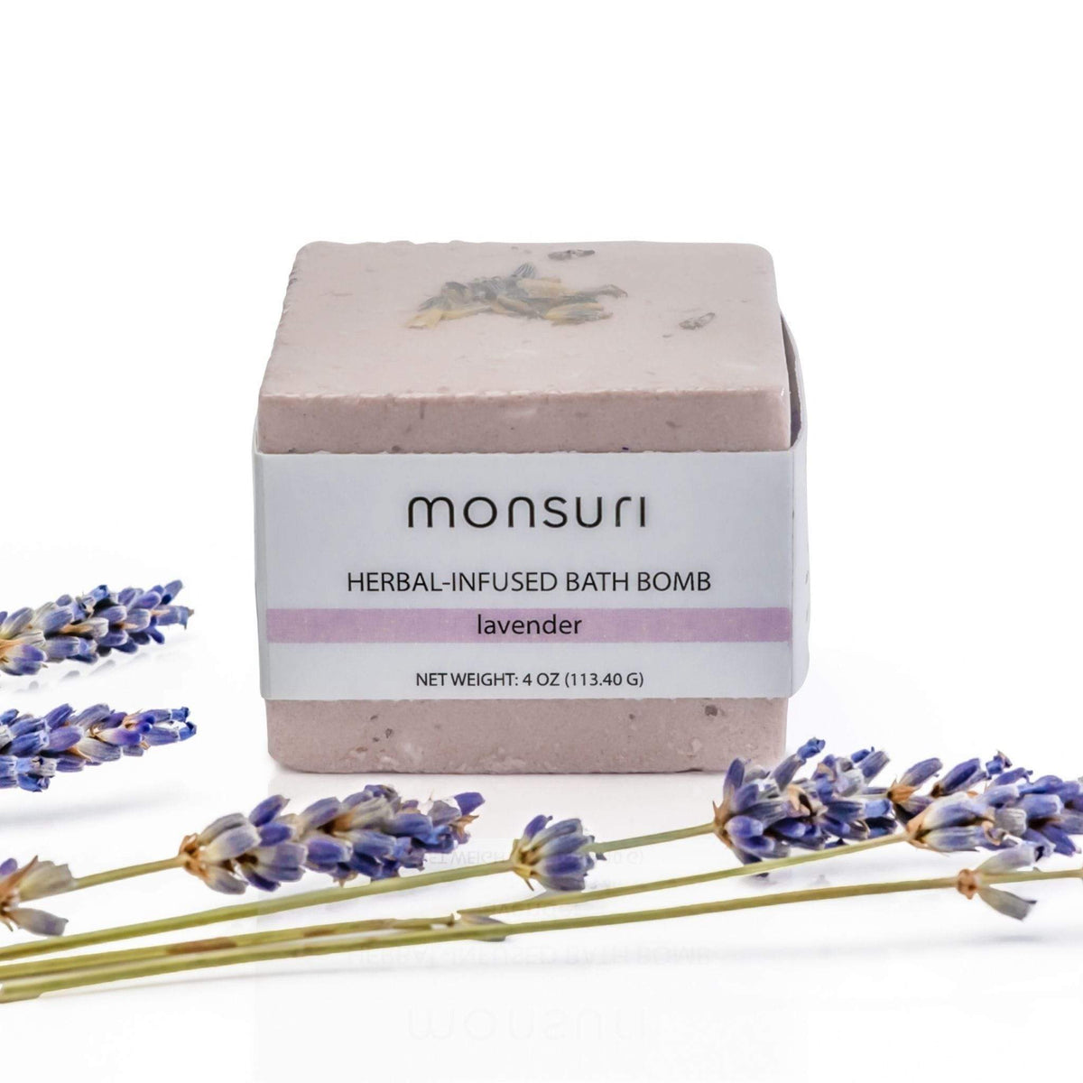 Luxurious lavender bath bomb placed against a white backdrop.